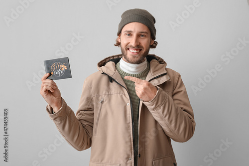 Young man with gift card on...