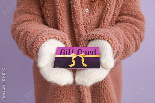 Young woman with gift card ...