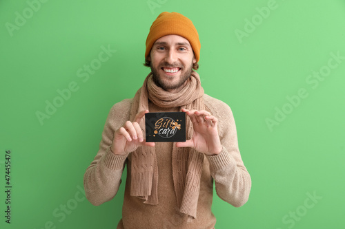Young man with gift card on...