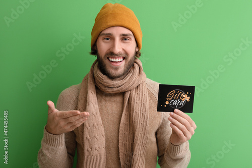 Young man with gift card on...