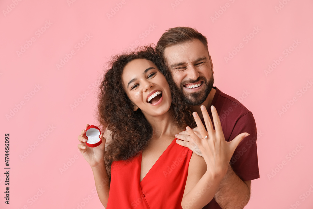 Happy young engaged couple on color background Happy young engaged couple on color background