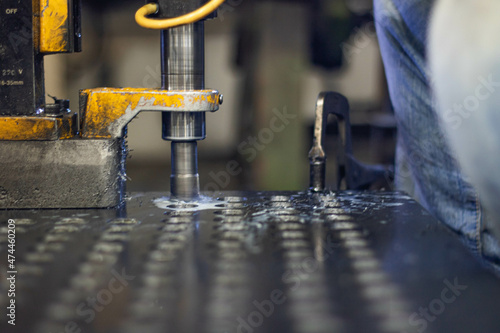 Drill holes in the steel mill with a drill.