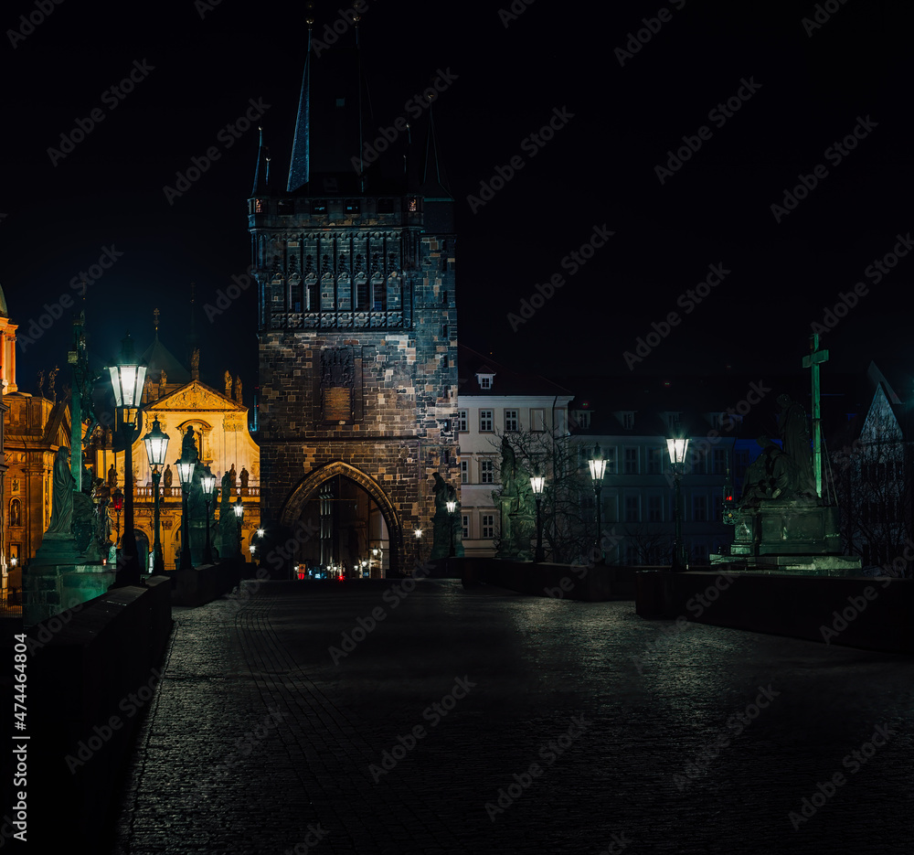 Fototapeta premium street lamps and old tower on Charles Bridge in the city of Prague at night 2021