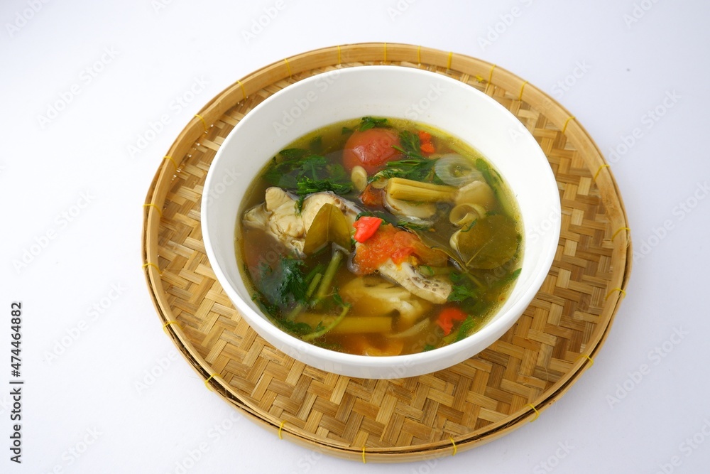 Boiled tilapia in white bowl on bamboo isolated on white background.