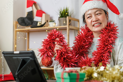 asian woman celebrate new year and christmas party with tablet video call friends at home