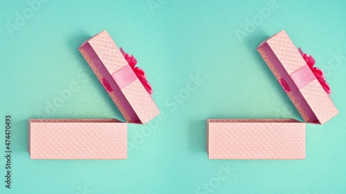 Wallpaper Mural Double pink gift with ribbon open on cyan background. Stop motion animation Torontodigital.ca