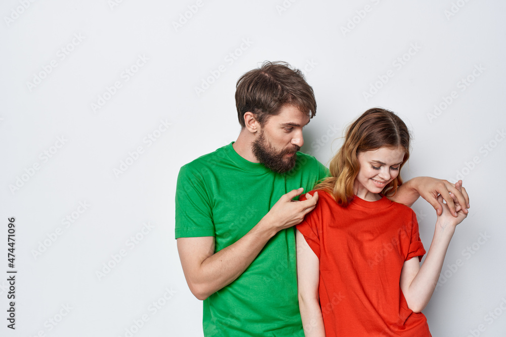 a young couple hug friendship colorful t-shirts family studio lifestyle a young couple hug friendship colorful t-shirts family studio lifestyle