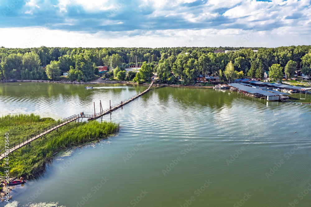 Fototapeta premium Pontoon bridge over the Razdelnaya River. Berdsk, Russia