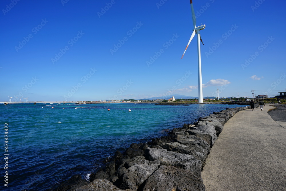 a wonderful seascape with lighthouse and wind power plant
