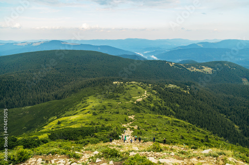 Mountain Hiking Through a Large Green Meadow photo