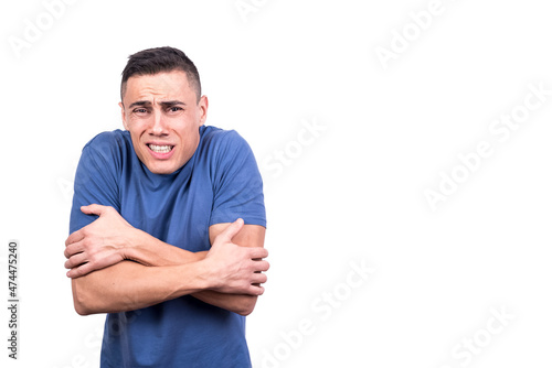 Man facing the camera while gesturing he is cold