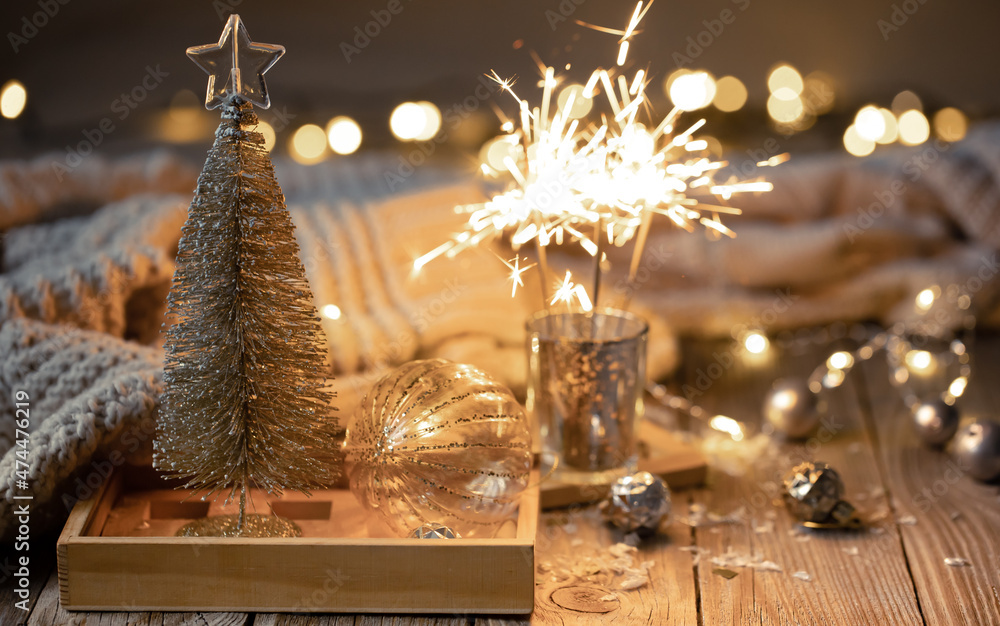 Cozy Christmas background with glowing sparklers and decor details.