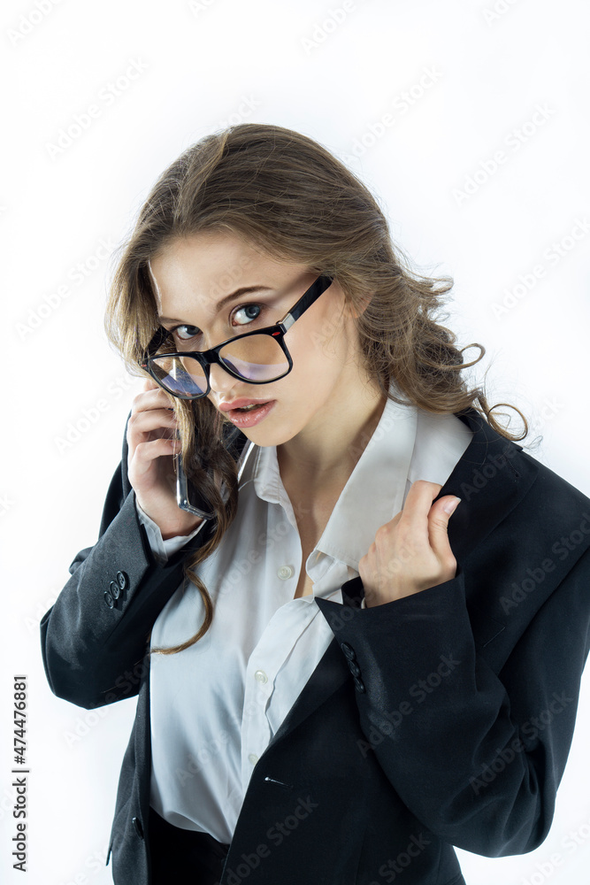 A pretty business woman, confident of success, in a black jacket. Full-length portrait on a white background. A pretty business woman, confident of success, in a black jacket. Full-length portrait on a white background.