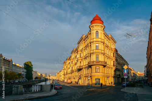Residential house of the late nineteenth century from the Kokushkin Bridge on the embankment of the Griboyedov Canal on a sunny day, St. Petersburg, Russia