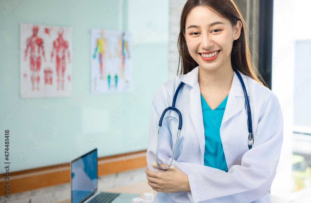 Confident young Asia female doctor in white medical uniform with stethoscope looking at camera and smiling health hospital.Portrait of a smiling doctor in office. Confident young Asia female doctor in white medical uniform with stethoscope looking at camera and smiling health hospital.Portrait of a smiling doctor in office.