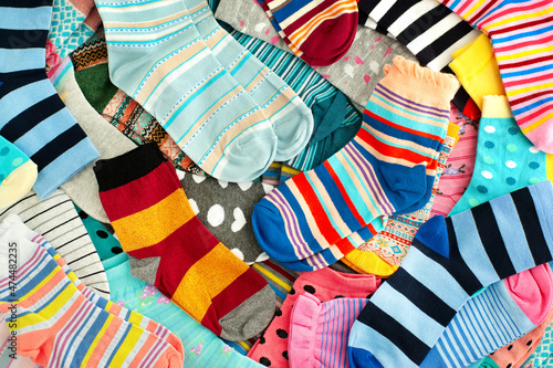 Fototapeta Naklejka Na Ścianę i Meble -  A bunch of colorful socks. Many different colorful socks for cold seasons. Clothing in the form of socks.