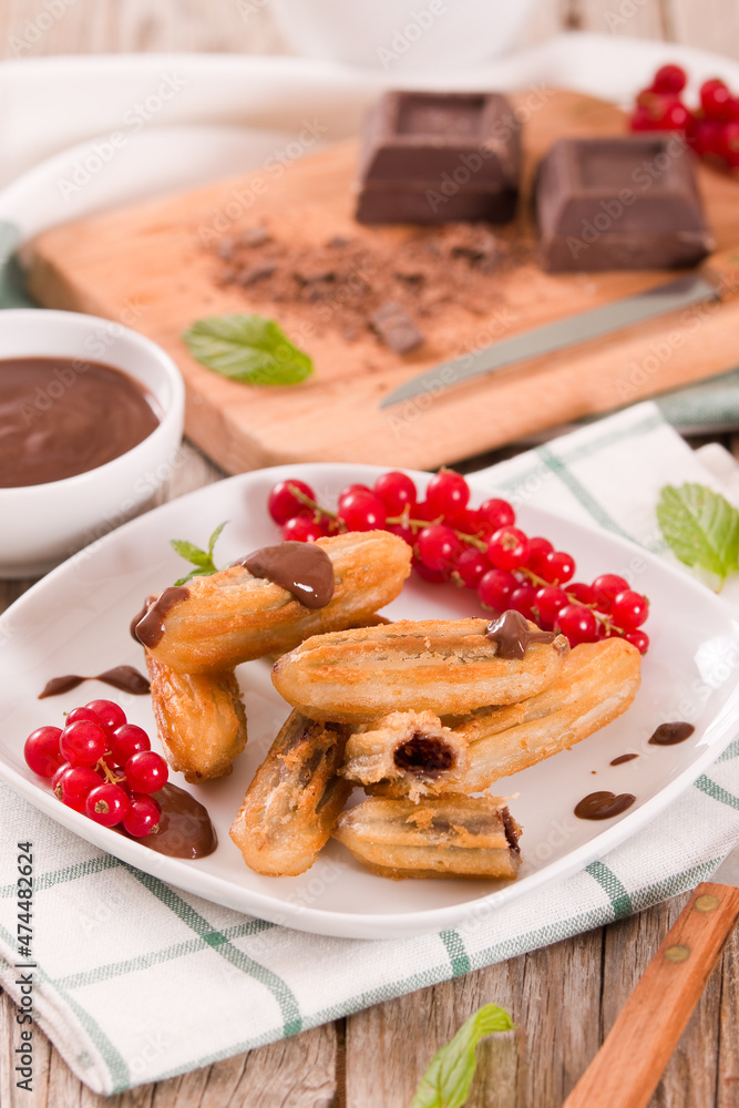 Mini churros with chocolate dipping sauce. Mini churros with chocolate dipping sauce.
