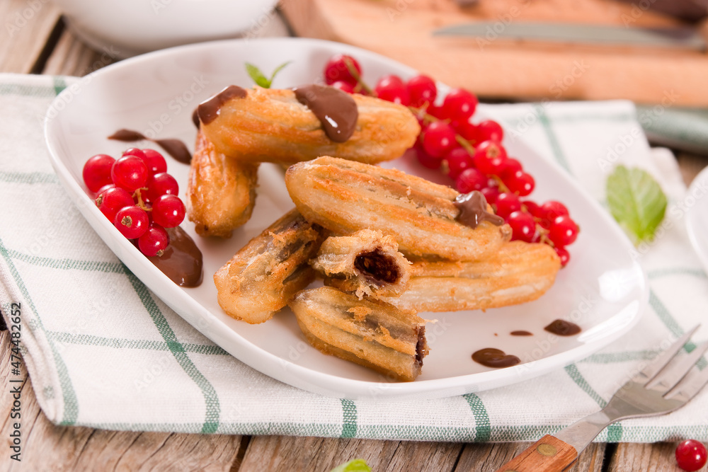 Mini churros with chocolate dipping sauce. Mini churros with chocolate dipping sauce.