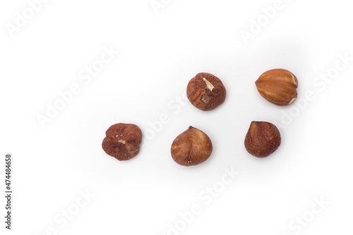 Five hazelnuts isolated on white background