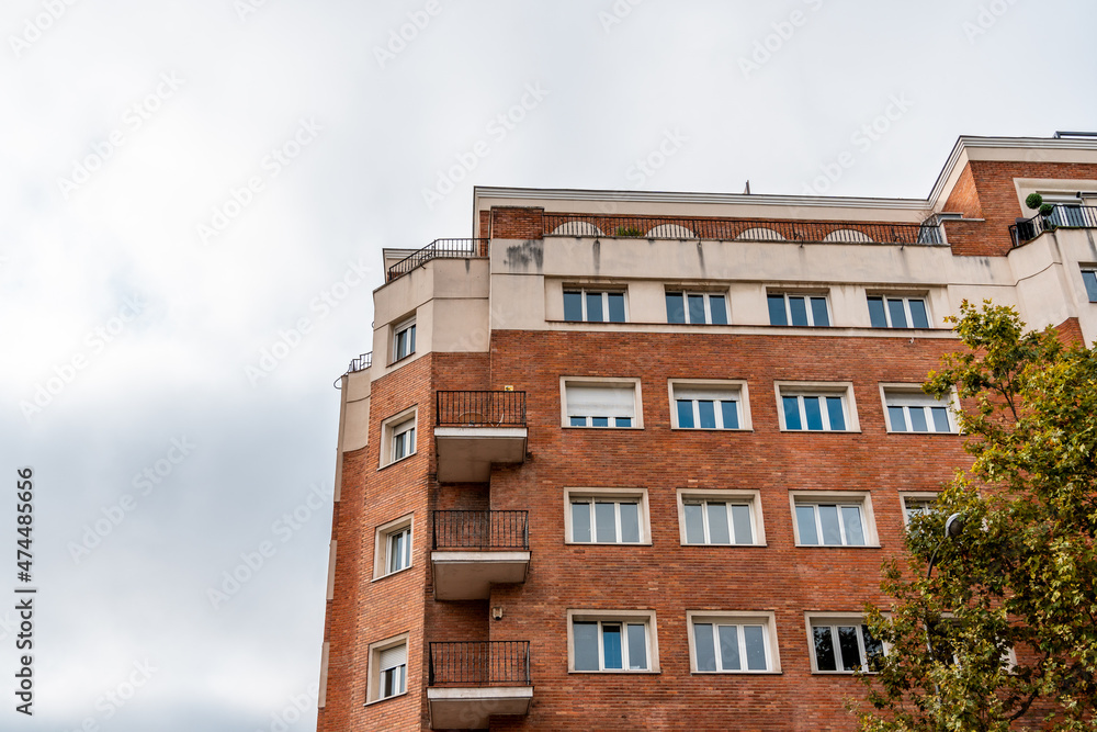 Residential brick building facade against sky in Madrid, Spain