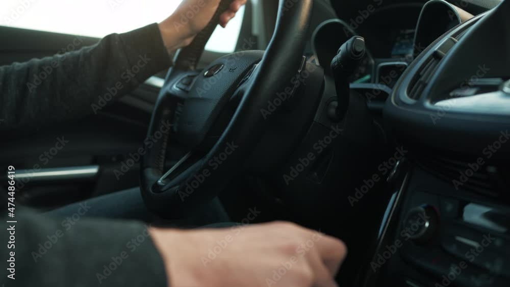 Man driving in innovative automated car using self-parking autopilot for parking on parking lot Man driving in innovative automated car using self-parking autopilot for parking on parking lot