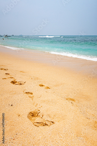 Beach by the ocean with yellow sand in the tropics.