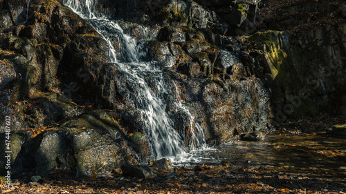 Water runs down the rocks. Autumn.