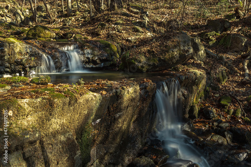 Stepped waterfall in the woods. Autumn.