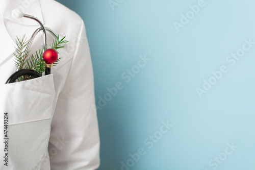 Doctor with stethoscope with christmas's ball instead of instrument part