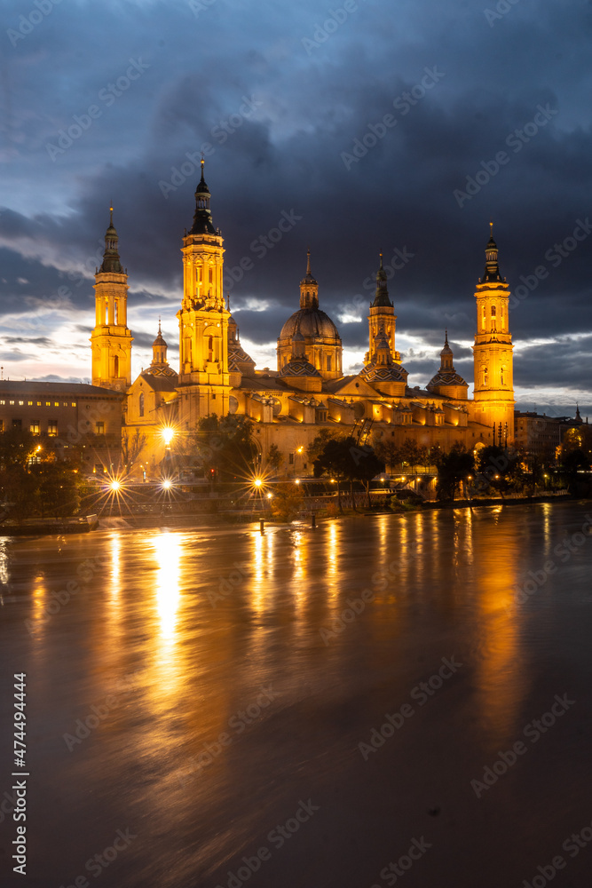 Basilica De Nuestra Señora del Pilar illuminated at night from the Ebro river in the city of Zaragoza, Aragon. Spain