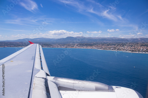 Wing view of arriving airplane in Nice, France © Photofex