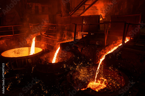 A jet of molten steel is poured into ladles. Metallurgical industry