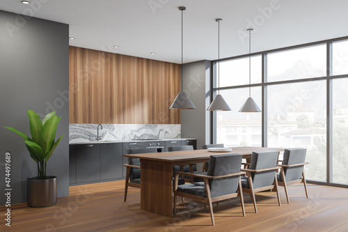 Dark kitchen interior with table and seats  wooden floor and window