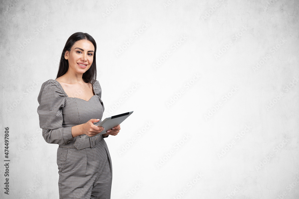 Smiling young attractive businesswoman wearing formal dress is h Smiling young attractive businesswoman wearing formal dress is h