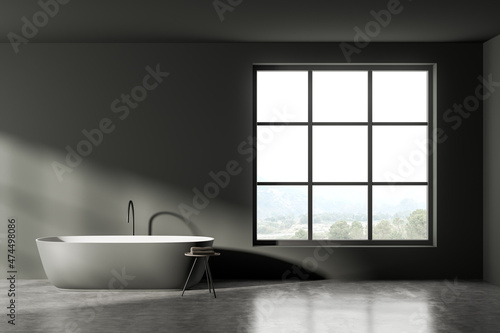 Dark bathroom interior with bathtub  table with towels and window. Mockup