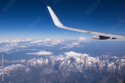 Airplane wing view on a summer sunny day with the Mont Blanc mountain area below