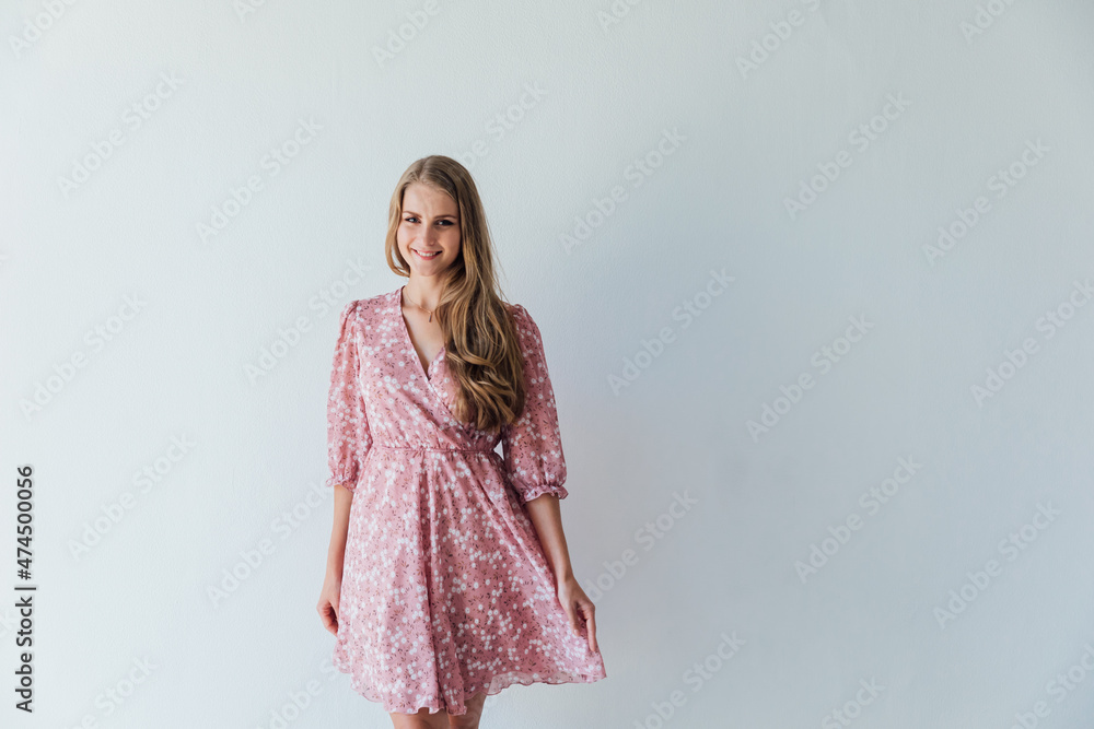 beautiful blonde woman in a light summer pink dress beautiful blonde woman in a light summer pink dress