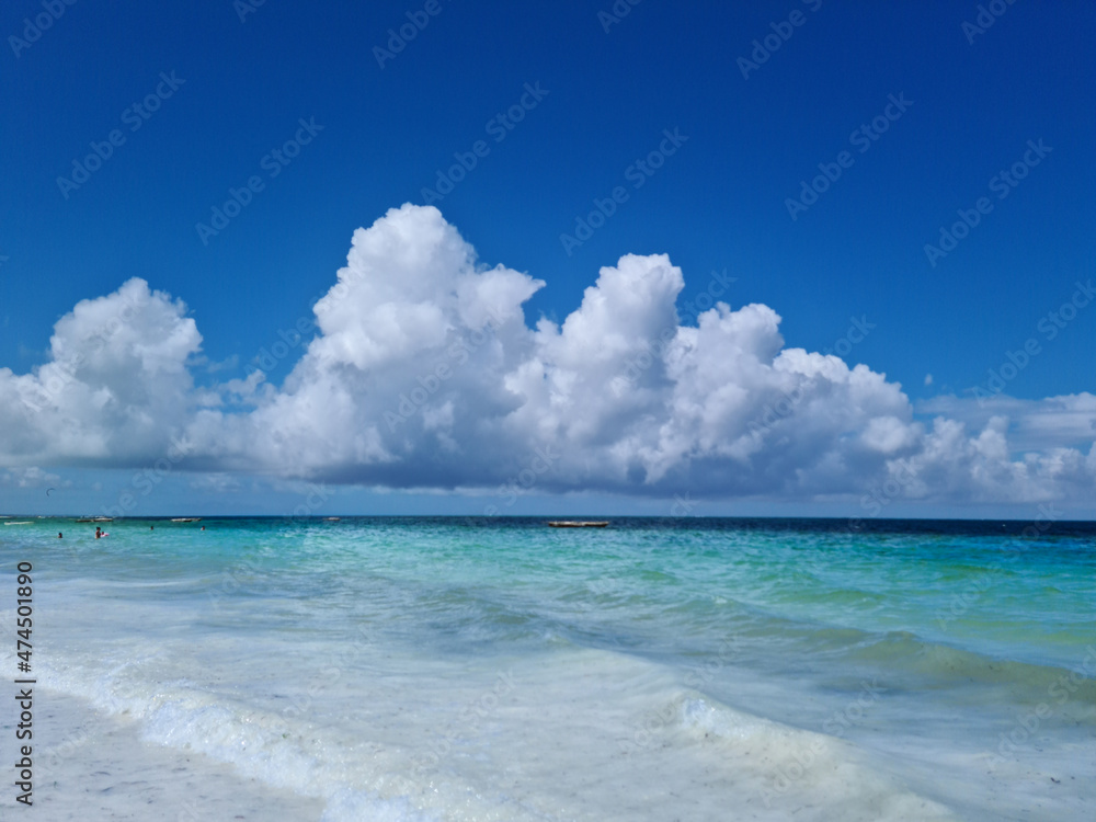Beautiful, exotic and natural tropical landscape, beach with white sand. Turquoise Indian Ocean on background blue sky with white big clouds on sunny summer day, Zanzibar Island, Afica, Nungwi, Kiweng Beautiful, exotic and natural tropical landscape, beach with white sand. Turquoise Indian Ocean on background blue sky with white big clouds on sunny summer day, Zanzibar Island, Afica, Nungwi, Kiweng