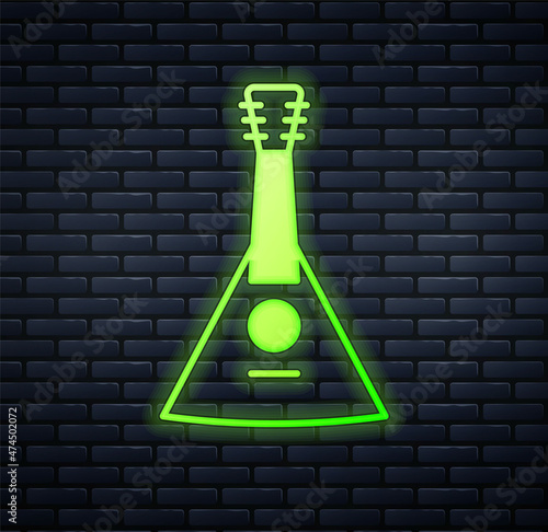 Glowing neon Musical instrument balalaika icon isolated on brick wall background. Vector