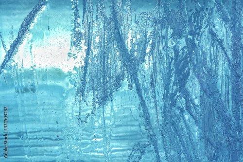 The texture and pattern of transparent ice with frozen air bubbles. Abstract background for the design.