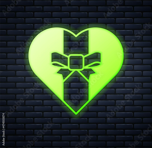 Glowing neon Gift box icon isolated on brick wall background. Merry Christmas and Happy New Year. Vector