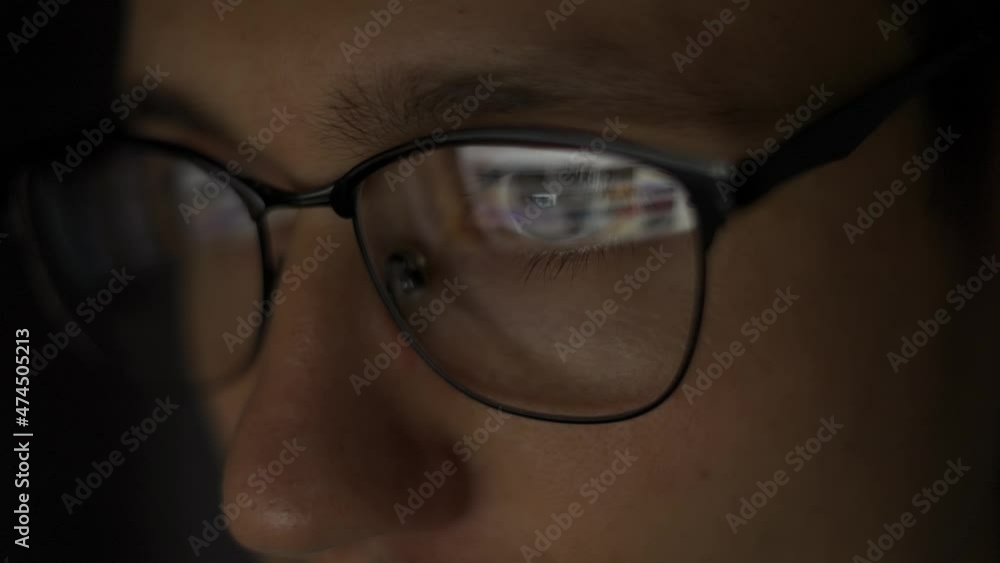 Businessman working at night looking at monitor, reflections in eyeglasses. Surfing the inthernet Businessman working at night looking at monitor, reflections in eyeglasses. Surfing the inthernet