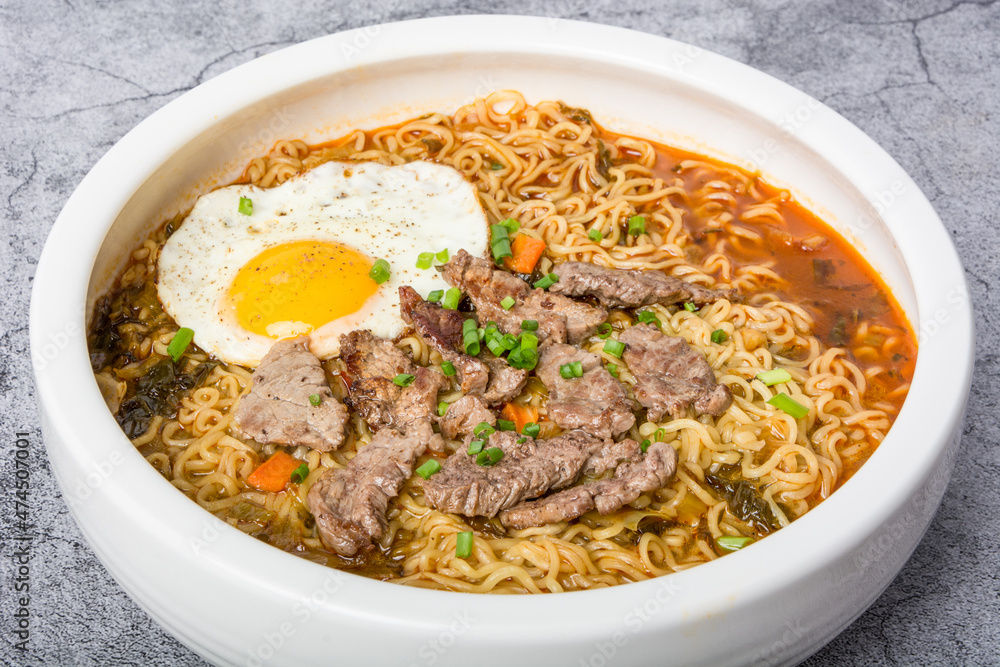 A basin of Korean instant noodles on a white background A basin of Korean instant noodles on a white background