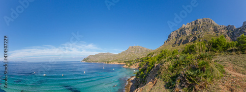 Turquoise water, rocky coast line and boats at beautiful beach Cala na clara near Betlém at Mallorca island, Mediterranean Sea, Spain (Panorama)