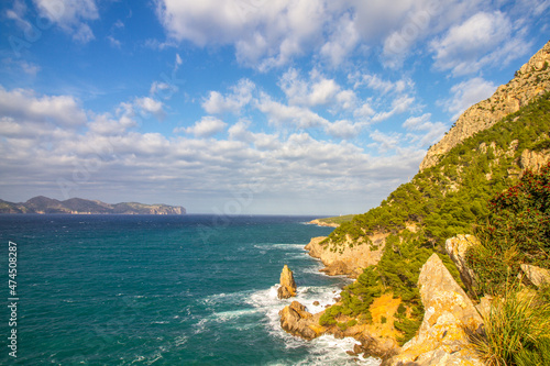 Coast of the Mediterranean Sea at Alc  dia peninsula with clouds and blue sky  Mallorca island  Balearic islands  Spain  Europe