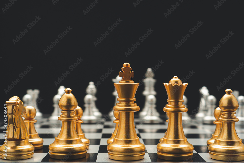 Chess pieces on board game on black background. Business and strategy concept Chess pieces on board game on black background. Business and strategy concept