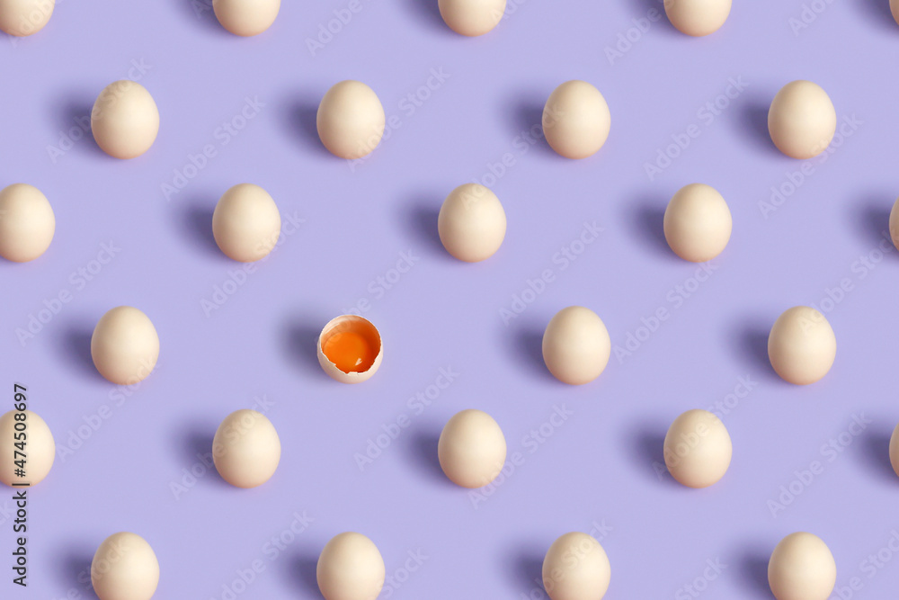 A pattern of eggs on a purple background, one broken egg. A pattern of eggs on a purple background, one broken egg.