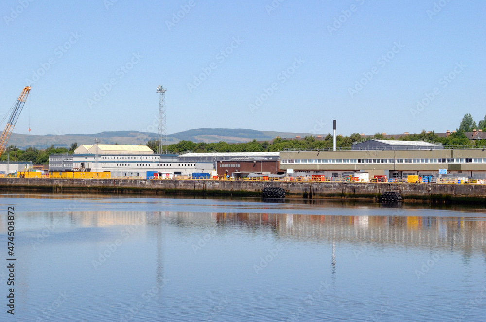 River View of Industrial Buildings and Cranes against Blue Sky