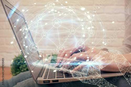 Double exposure of woman hands typing on computer and social network theme hologram drawing. People media concept.