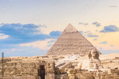 Great Sphinx against the background of the pyramids of the pharaohs Cheops  Khafren  and Mikerin in Giza  Egypt
